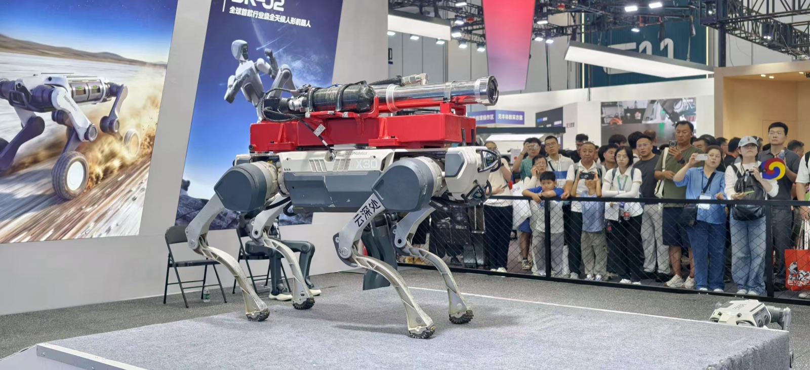 DEEP Robotics X30 quadruped with fire-fighting payload — extinguisher tank and nozzle — at WRC 2026