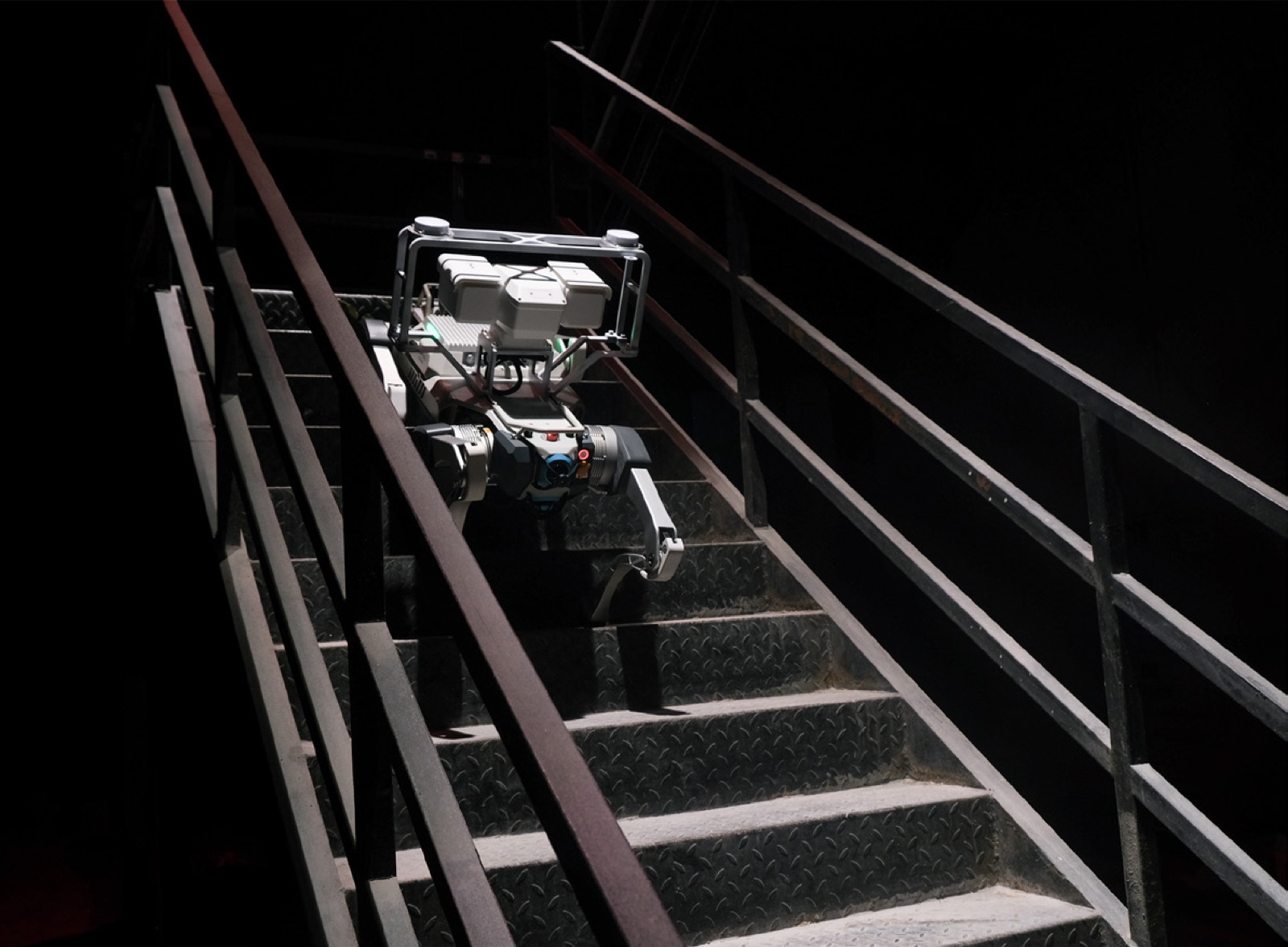 Compact scout-class inspection quadruped on industrial stairs